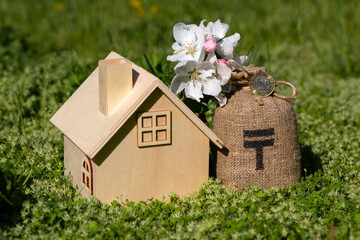 Bag for money with the symbol of the Kazakh currency - tenge and a branch of a blossoming apple tree