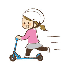 ヘルメットを被ってキックボードに乗っている女児