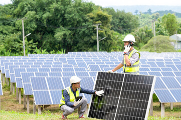 A team of male engineers is about to install solar panels. at the solar power station Engineer team...