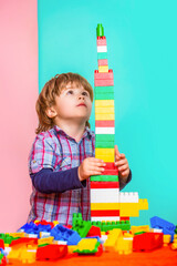 Little boy playing with lots of colorful plastic blocks constructor. Child playing with colorful...