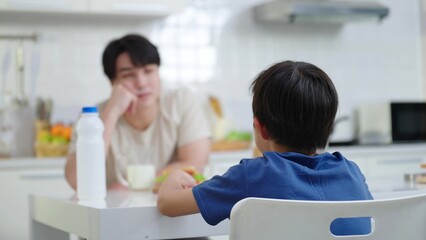 Asian father talking and scolding his son at home. Serious dad punish little upset guilty child boy. Fatherhood and childhood concept, Single father concept