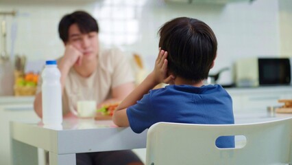 Obraz premium Son closing ears while father scolding. Boy child avoid ignore listening to serious father talking