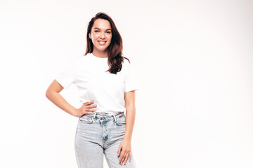 Young beautiful woman. Trendy carefree model in casual summer white T-shirt and blue jeans. Positive female isolated on white in studio. Cheerful and happy. Copy space, mockup