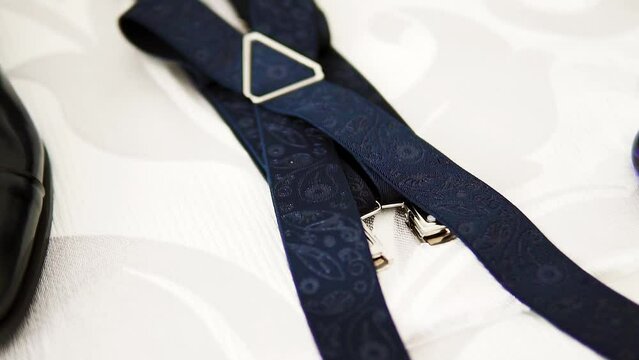 Men's suspenders, wedding accessories prepared on a wedding. Detail shot.