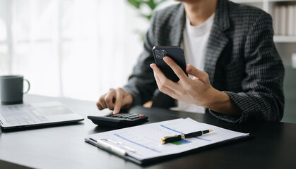 Confident businessman working on laptop,tablet and smartphone at her workplace at office...