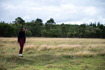 Happy woman seen standing in field