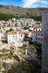 Fototapeta na wymiar View of an area of ruins surrounded by historic stone buildings located within the walls of the old town of Dubrovnik, Croatia, a remarkably well-preserved UNESCO site.