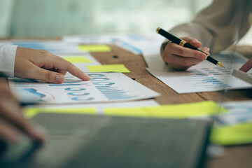 Business partners use laptops to analyze company financial budget reports, graphs and progress of work, costs and planning for the future in the office, meeting ideas.

ไทย
