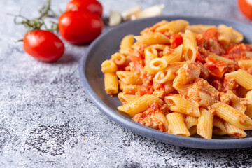 Pennette with tuna and cherry tomatoes. Typical dish of traditional Italian and Mediterranean cuisine. Healthy and balanced dish suitable for both lunch and dinner.