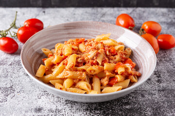 Pennette with tuna and cherry tomatoes. Typical dish of traditional Italian and Mediterranean cuisine. Healthy and balanced dish suitable for both lunch and dinner.