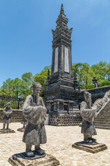 Fototapeta premium Life size statues of warriors below a commemorative tower at a temple at Hue in Vietnam
