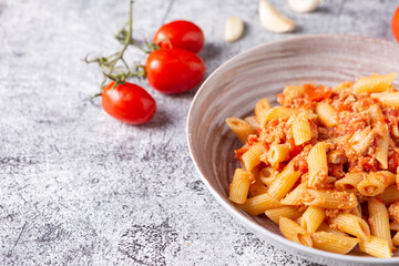 Pennette with tuna and cherry tomatoes. Typical dish of traditional Italian and Mediterranean cuisine. Healthy and balanced dish suitable for both lunch and dinner.
