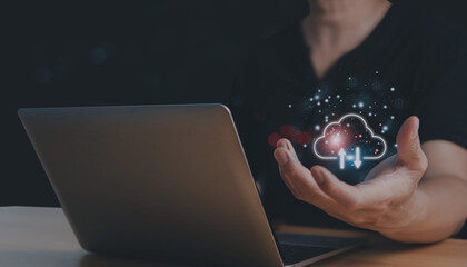 A young man is using a laptop that has a cloud computing diagram shown. cloud computing. saving of data. Concept for networking and internet services.