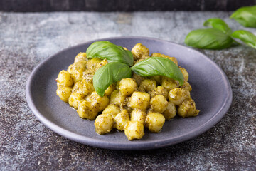 potato gnocchi with homemade basil pesto. Typical dish of traditional Italian cuisine, suitable for those who follow a vegetarian diet.