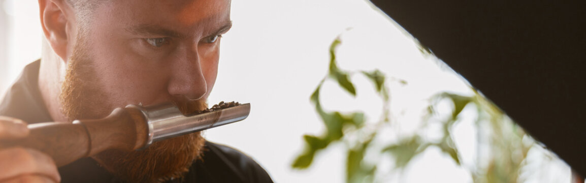 Close Up Of Barista Inhaling The Aroma Of Coffee Beans In Own Manufacturing