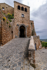 Fototapeta na wymiar Porta di Santa Maria at the entrance to Civita di Bagnoregio, Italy