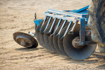 Close up of a disc harrow system, cultivate the soil. The selective focus of the blades were...