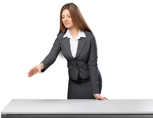 Beautiful young businesswoman standing against table top