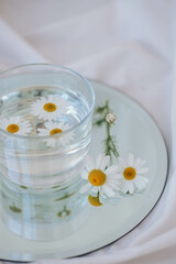 Fototapeta na wymiar Chamomile flowers in vases on the table. Chamomile flowers in glass vase.