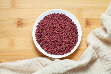 Red yeast rice in a ceramic dish. Chinese traditional food and medicine.