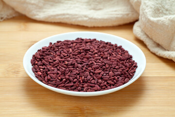 Red yeast rice in a ceramic dish. Chinese traditional food and medicine.