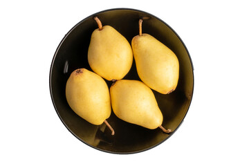 Four organic pears in black ceramic plate isolated on white background, top view, macro.