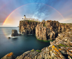 Rainbow over Neist Point Lighthouse on the green cliffs of the Isle of Skye, Scotland - obrazy, fototapety, plakaty