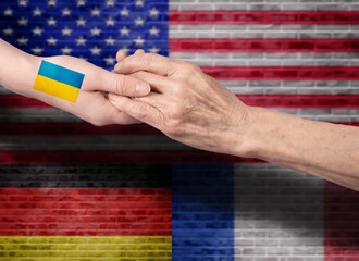 Handshake between USA, Germany, France and Ukraine. The flag of America, Germany, France extends a...