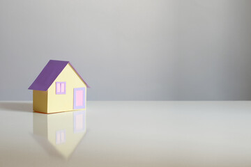 little paper house on gray background