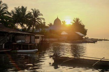 Sunset over a mosque in a village in Raja Ampat, Papua, Indonesia
