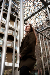 Mood portrait of model woman posing in metal structure in London.