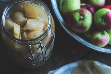 Apple cider vinegar in hinged lid jar on rustic background