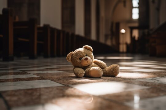 Concept of child abuse in church: teddy bear on the floor in cathedral