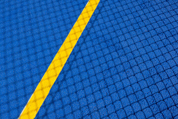 Sport field court background. Blue rubberized and granulated ground surface with yellow lines and...