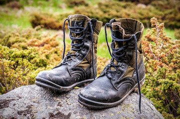 Military hiking boots on the stone