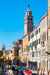 Fototapeta premium Narrow canals of Venice city with old traditional architecture, bridges and boats, Veneto, Italy. Tourism concept. Architecture and landmark of Venice. Cozy cityscape of Venice.