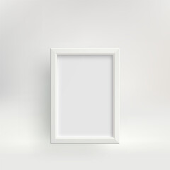 White vertical photo frame with a shadow against a light wall.
