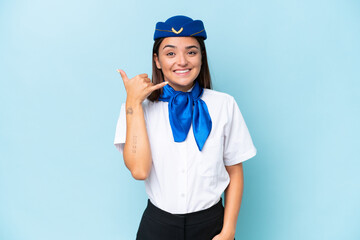 Airplane stewardess caucasian woman isolated on blue background making phone gesture. Call me back sign