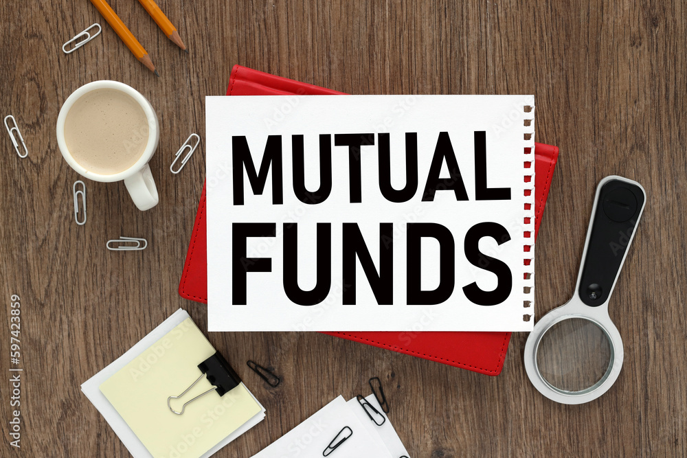 Poster mutual funds open notepad with text on a rustic background. business concept. envelope calculator ma