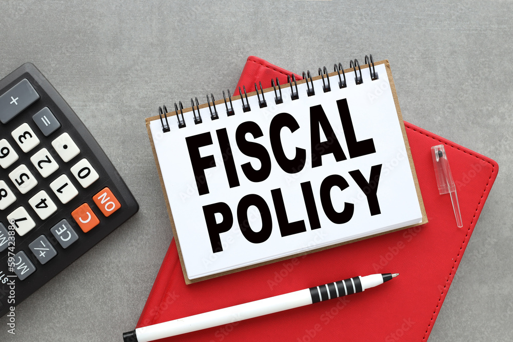 Poster fiscal policy text on open notepad near calculator. business concept