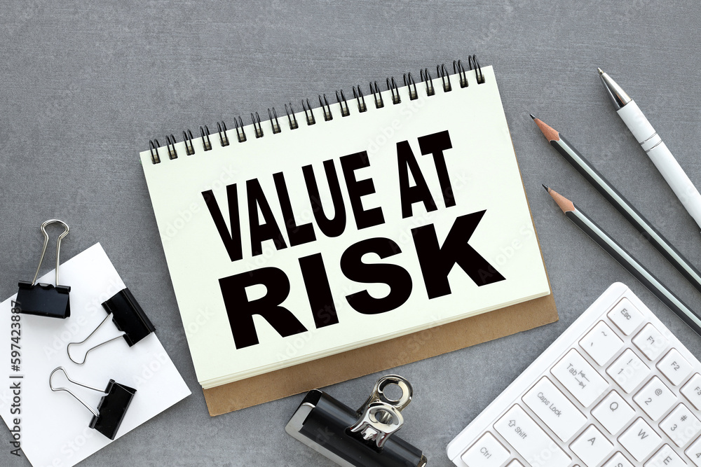 Poster value at risk text on an open notepad. business concept