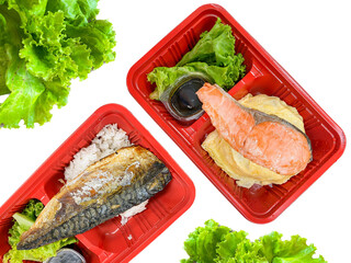 Saba and salmon fish grilled with salad in the food container on the table