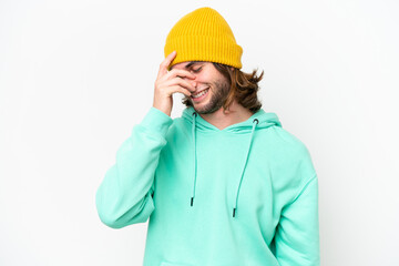 Young handsome man isolated on white chroma background laughing