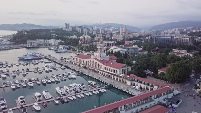 Aerial rising view of yachts and boats docked at sochi port, oligarch society