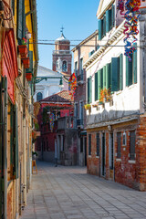 Fototapeta na wymiar Cozy narrow streets of Venice city with old traditional architecture, Veneto, Italy. Tourism concept. Architecture and landmark of Venice. Cityscape of Venice.