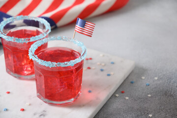 Patriotic red pomegranate margarita cocktail on gray background. Festive beverages for Independence...