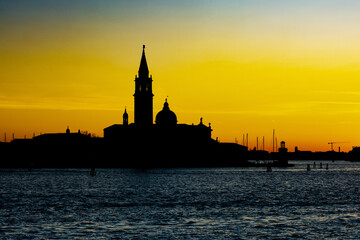 Fototapeta premium Beautiful picturesque panoramic view on abbey San Giorgio Maggiore (Abbazia di San Giorgio Maggiore) at sunset. Silhouette of Isola di San Giorgio Maggiore. Venice, Italy.
