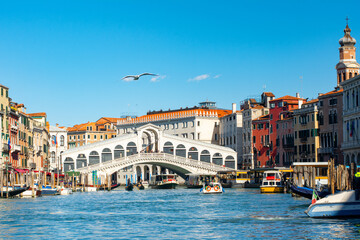 Fototapeta na wymiar Stunning view of the Grand Canal of Venice, view of the Lagoon near The Rialto bridge in a sunny weather with clear sky, Italy