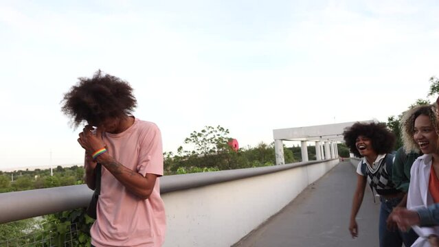 Classmates bullying a student, young multiracial teenagers leaving class