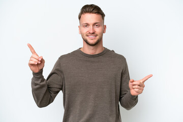 Young blonde caucasian man isolated on white background pointing finger to the laterals and happy